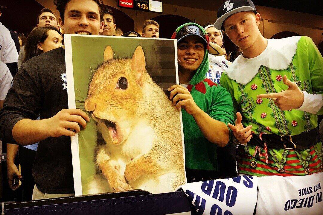 Fans holding a giant squirrel poster for Yauhen